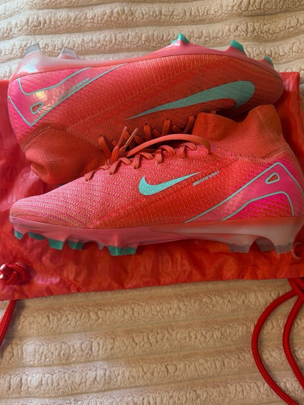 Nike Women's Pink Soccer Cleats with Teal Swoosh